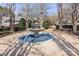 Outdoor circular fountain surrounded by trimmed bushes, trees, sidewalks and two park benches at 4548 Antelope Ln, Charlotte, NC 28269