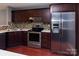 Modern kitchen featuring stainless steel appliances, granite countertops, and dark wood cabinets at 4548 Antelope Ln, Charlotte, NC 28269