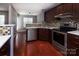 Modern kitchen featuring stainless steel appliances, granite countertops, and dark wood cabinets at 4548 Antelope Ln, Charlotte, NC 28269