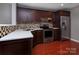 Modern kitchen featuring stainless steel appliances, granite countertops, and dark wood cabinets at 4548 Antelope Ln, Charlotte, NC 28269