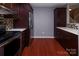 Modern kitchen featuring stainless steel appliances, granite countertops, and dark wood cabinets at 4548 Antelope Ln, Charlotte, NC 28269