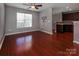 Spacious living room with hardwood floors, a ceiling fan, and a large window at 4548 Antelope Ln, Charlotte, NC 28269