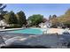 Community pool with a clear blue water surrounded by seating, landscaping, and a small pool house at 4548 Antelope Ln, Charlotte, NC 28269