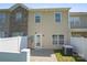 Neutral siding with a small patio area leading to a grassy fenced-in yard, and AC unit at 4554 Craigmoss Ln, Charlotte, NC 28278