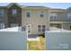 The back of the home features neutral siding, a door to the backyard and fenced yard at 4554 Craigmoss Ln, Charlotte, NC 28278