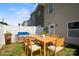 Backyard patio area with wooden dining table and chairs, plus a grill, great for outdoor living at 4554 Craigmoss Ln, Charlotte, NC 28278