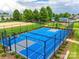 Community basketball court with blue surface surrounded by a fence for active play and recreation at 4554 Craigmoss Ln, Charlotte, NC 28278
