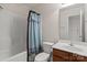A full bath with tile flooring and a wood vanity at 4554 Craigmoss Ln, Charlotte, NC 28278
