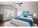 Bright bedroom featuring a ceiling fan, natural light, and stylish decor at 4554 Craigmoss Ln, Charlotte, NC 28278