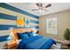 Bedroom featuring horizontal stripe accent wall and a bed with blue decor at 4554 Craigmoss Ln, Charlotte, NC 28278