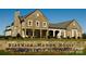 Stunning stone home with lush landscaping and a welcoming front entrance and front sign at 4554 Craigmoss Ln, Charlotte, NC 28278