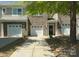 Charming townhome with a brick and siding facade and a well-manicured front yard with a single-car garage at 4554 Craigmoss Ln, Charlotte, NC 28278
