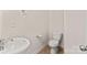 Cozy half bathroom featuring a pedestal sink and toilet at 4554 Craigmoss Ln, Charlotte, NC 28278