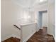 Upstairs hallway featuring hardwood floors, neutral walls, and modern chandelier at 4554 Craigmoss Ln, Charlotte, NC 28278