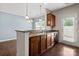 Kitchen area featuring dark wood cabinets, granite countertops, stainless sink, and eat-in bar area at 4554 Craigmoss Ln, Charlotte, NC 28278