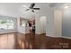 Open-concept living area with hardwood floors, seamlessly connecting the living room and kitchen in a modern design at 4554 Craigmoss Ln, Charlotte, NC 28278