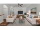 Bright living room with neutral tones, hardwood floors, and a ceiling fan, staged for a cozy and inviting atmosphere at 4554 Craigmoss Ln, Charlotte, NC 28278