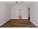An open living room showcases dark hardwood floors and an arched doorway at 4554 Craigmoss Ln, Charlotte, NC 28278