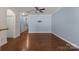 Spacious living room featuring hardwood floors, ceiling fan, and a neutral color palette, awaiting personal touches at 4554 Craigmoss Ln, Charlotte, NC 28278