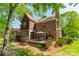 An outdoor seating area on the patio of a brick home with landscaped garden at 4599 Rustling Woods Dr, Denver, NC 28037