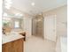 Spacious bathroom featuring double vanity, glass shower, and separate tub at 4599 Rustling Woods Dr, Denver, NC 28037