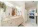 Well-lit bathroom with dual sinks, vanity, and shower at 4599 Rustling Woods Dr, Denver, NC 28037