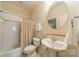 A clean bathroom features a tub/shower combo, toilet and pedestal sink at 4599 Rustling Woods Dr, Denver, NC 28037