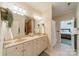 Bathroom with dual sinks, vanity, and access to the bedroom at 4599 Rustling Woods Dr, Denver, NC 28037