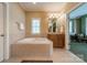 Spacious bathroom featuring a large soaking tub, vanity with sink, and a large window for natural light at 4599 Rustling Woods Dr, Denver, NC 28037