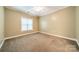 Well-lit, cozy bedroom with a neutral color palette and plush carpeting at 4599 Rustling Woods Dr, Denver, NC 28037
