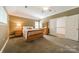 Comfortable bedroom with carpeted floors, natural light, and neutral décor for a relaxing retreat at 4599 Rustling Woods Dr, Denver, NC 28037