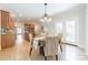 Open dining area with a view of the kitchen, hardwood floors, and natural light at 4599 Rustling Woods Dr, Denver, NC 28037