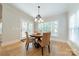 Cozy dining area with hardwood floors, natural light, and a stylish chandelier at 4599 Rustling Woods Dr, Denver, NC 28037