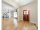 Elegant dining room with hardwood floors, chandelier, and decorative molding at 4599 Rustling Woods Dr, Denver, NC 28037