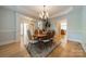 Elegant dining room featuring hardwood floors, a chandelier, and a neutral color palette at 4599 Rustling Woods Dr, Denver, NC 28037