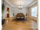Elegant dining room showcases hardwood floors, decorative rug, and chandelier lighting at 4599 Rustling Woods Dr, Denver, NC 28037