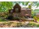 An outdoor seating area on the patio of a brick home with landscaped garden at 4599 Rustling Woods Dr, Denver, NC 28037