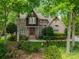 Charming brick home with mature landscaping, flowering bushes, and a welcoming front entrance at 4599 Rustling Woods Dr, Denver, NC 28037