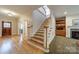 Elegant foyer with hardwood floors and staircase, showcasing the home's bright and welcoming entryway at 4599 Rustling Woods Dr, Denver, NC 28037