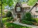 Charming brick home with a bay window, lush landscaping, and a well-manicured lawn at 4599 Rustling Woods Dr, Denver, NC 28037