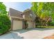 Three car garage with a brick exterior and well-maintained driveway at 4599 Rustling Woods Dr, Denver, NC 28037
