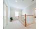 Bright hallway with natural light and elegant wood railing at 4599 Rustling Woods Dr, Denver, NC 28037