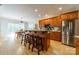Kitchen island featuring wooden cabinets, granite countertops, stainless steel appliances and bar stool seating at 4599 Rustling Woods Dr, Denver, NC 28037