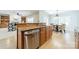 Well-lit kitchen island with stainless steel dishwasher and hardwood floors at 4599 Rustling Woods Dr, Denver, NC 28037