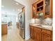 Kitchen featuring wooden cabinets, granite countertops, and stainless steel refrigerator at 4599 Rustling Woods Dr, Denver, NC 28037