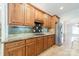 Modern kitchen with gas cooktop, tile backsplash, stainless steel appliances and wood cabinetry at 4599 Rustling Woods Dr, Denver, NC 28037