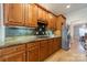 Kitchen showcasing wooden cabinets, granite countertops, stainless steel appliances, and tile backsplash at 4599 Rustling Woods Dr, Denver, NC 28037