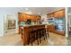 Kitchen island with wooden cabinets, granite countertops, stainless steel appliances and bar stool seating at 4599 Rustling Woods Dr, Denver, NC 28037