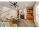 Spacious living room featuring a fireplace, built-ins and a staircase to the second floor at 4599 Rustling Woods Dr, Denver, NC 28037