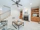 Relaxing living room featuring a cozy fireplace, built-in shelving, and neutral carpeting at 4599 Rustling Woods Dr, Denver, NC 28037